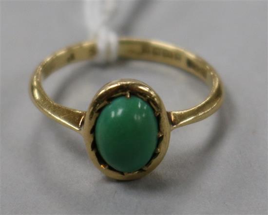An 18ct gold and oval green cabochon ring, size K.